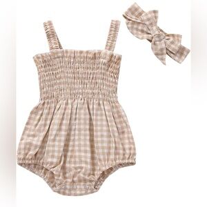 Newborn baby romper with matching bow.